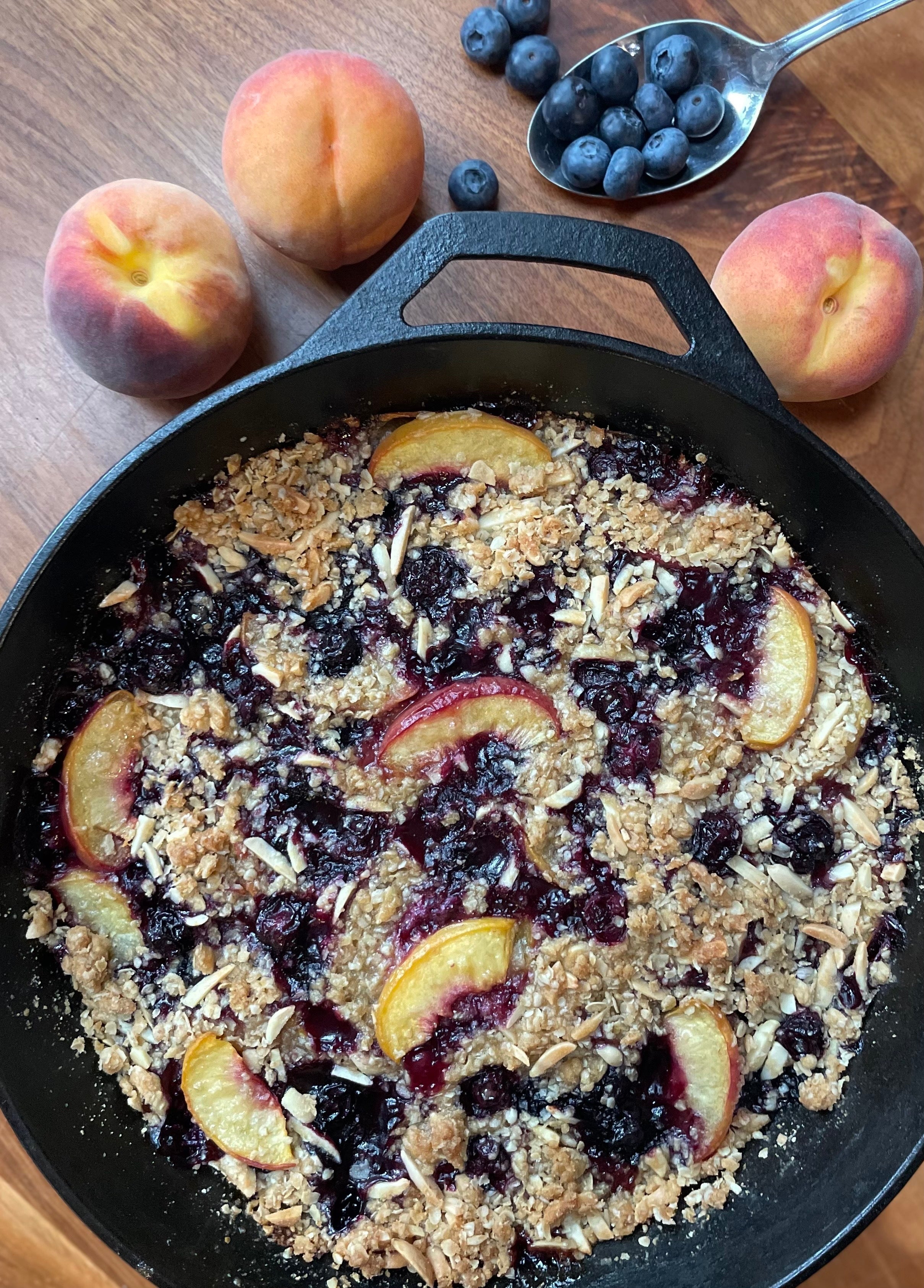 Blueberry & Peach Crisp pictured with extra peaches and blueberries