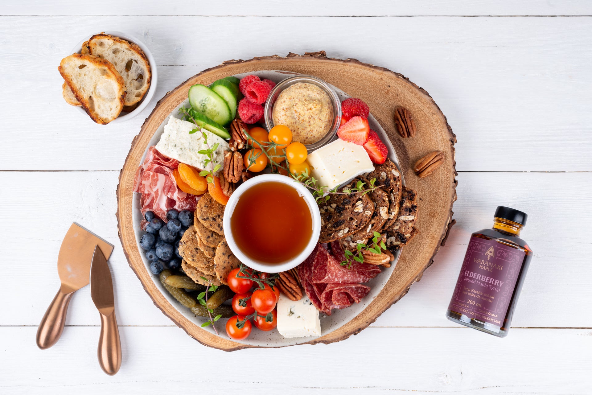 A Charcuterie Board with Elderberry Infused Maple Syrup in the middle as the dip