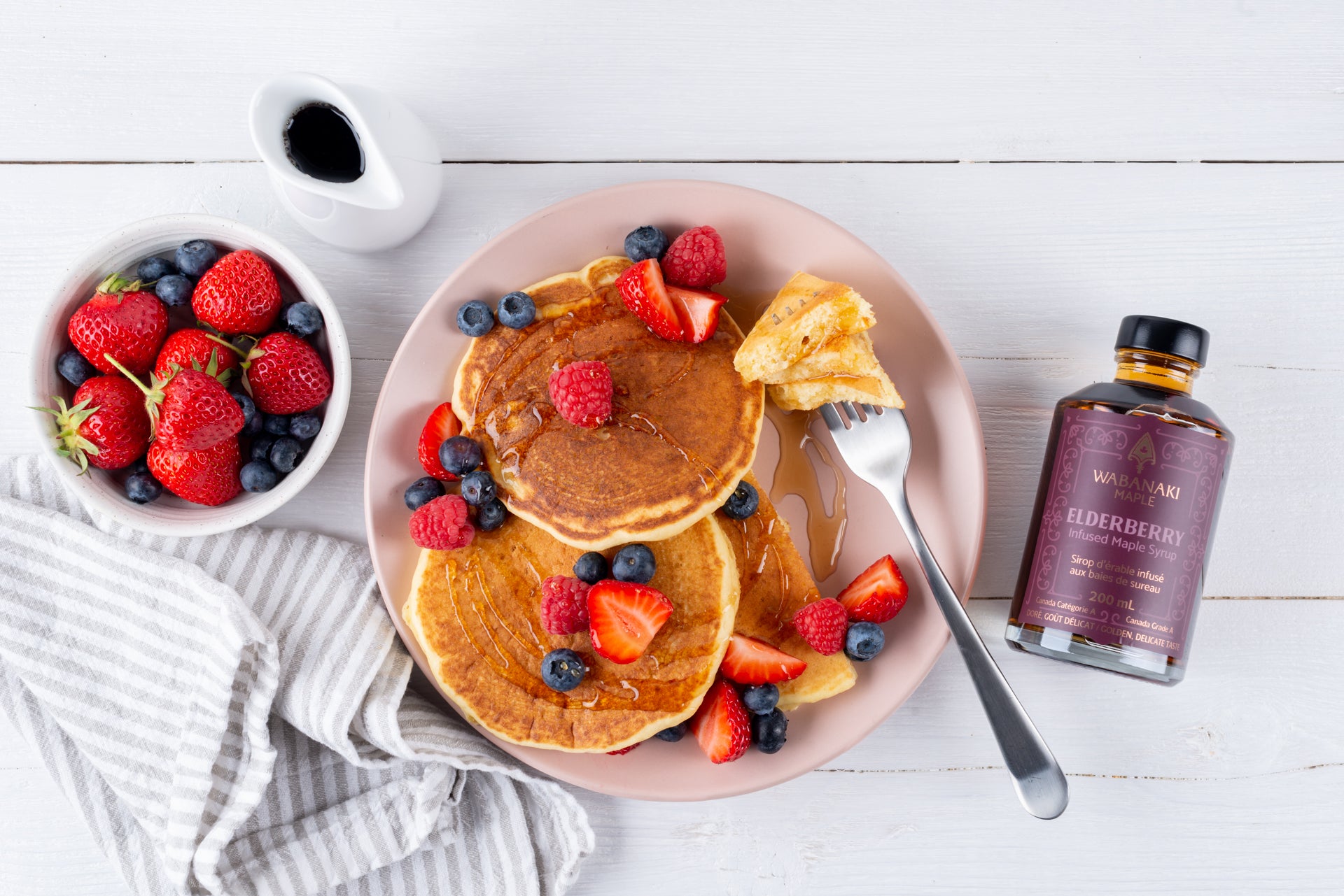 Wabanaki Maple Infused Maple Syrup with Elderberry Infused Maple Pancakes topped with berries and drizzled with Wabanaki Maple Syrup