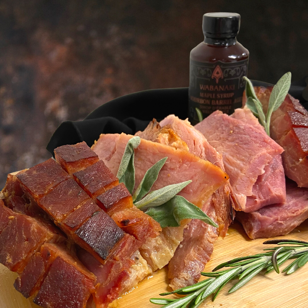 Pictured is ham with sage and sweetgrass beside Wabanaki Maple's barrel aged bourbon maple syrup
