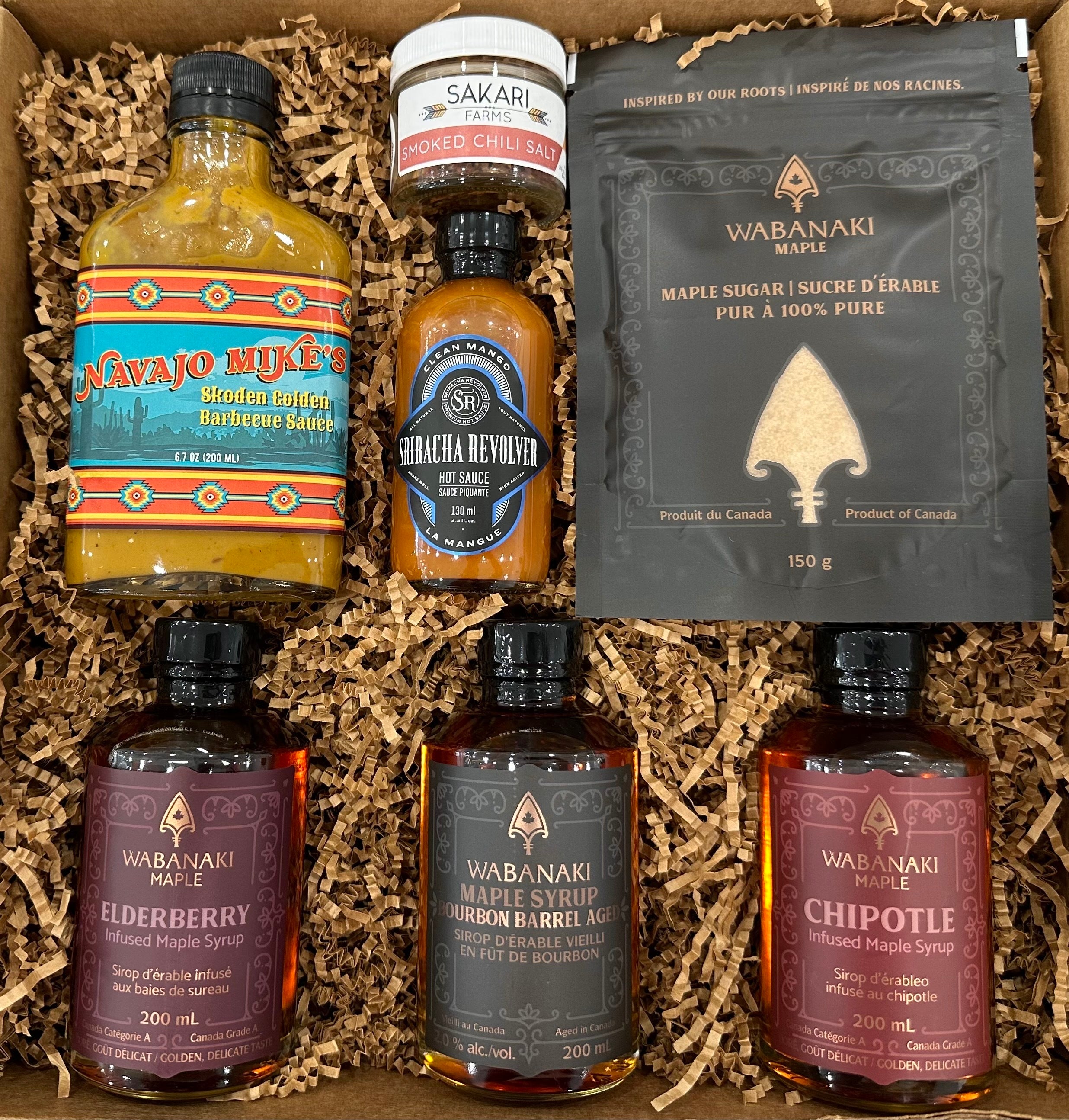 Wabanaki Maple Bareroots Revive Box including our infused maple syrup line, our barrel aged bourbon maple syrup, chipotle infused maple syrup, Navajo Mike's skoden Golden bbq sauce, Sriacha Revolver hot sauce and sakari famrs chili salt